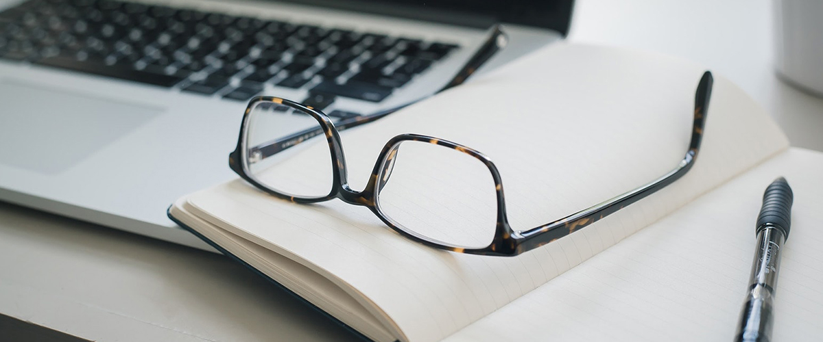 Conveyancer Glasses on Book